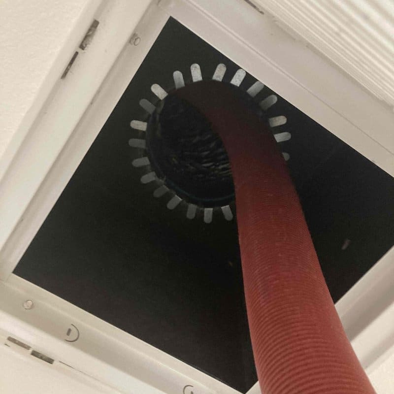 Duct Cleaning vacuum hose at a house in Hudson Florida