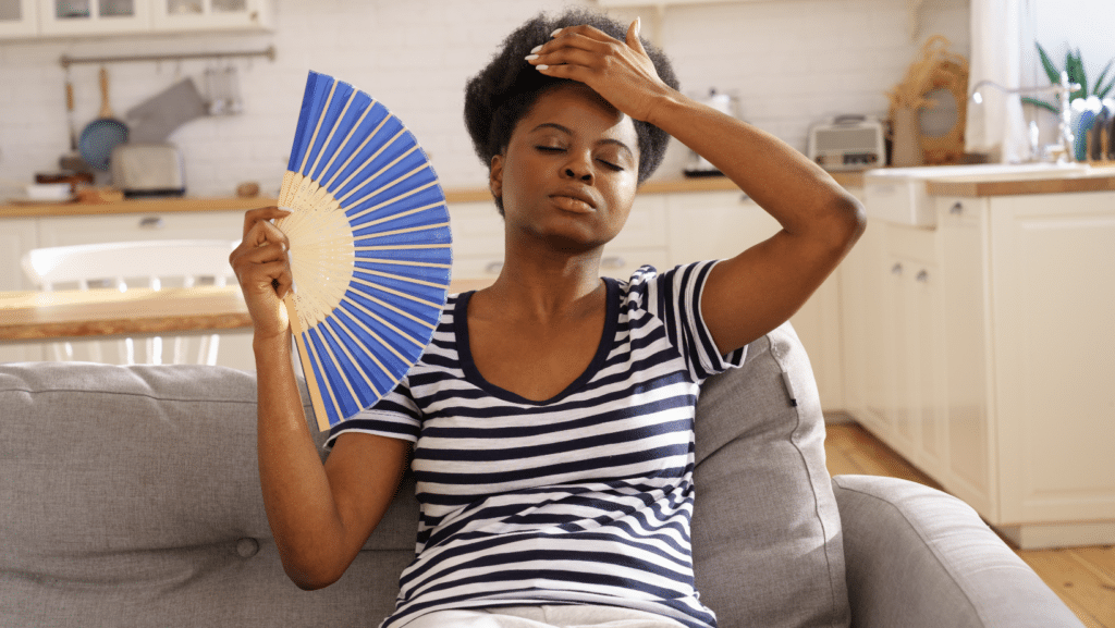 Woman with a fan inside of a hot house in Florida
